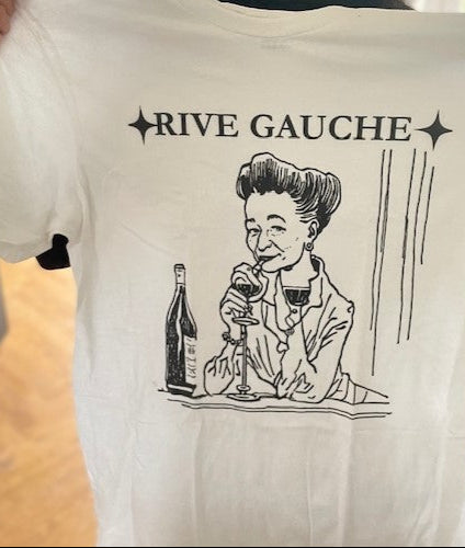 White t-shirt with black graphic and 'Rive Gauche' text held by a person.